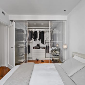 modern bedroom interior with wardrobe with glass door while the floor is made of hardwood